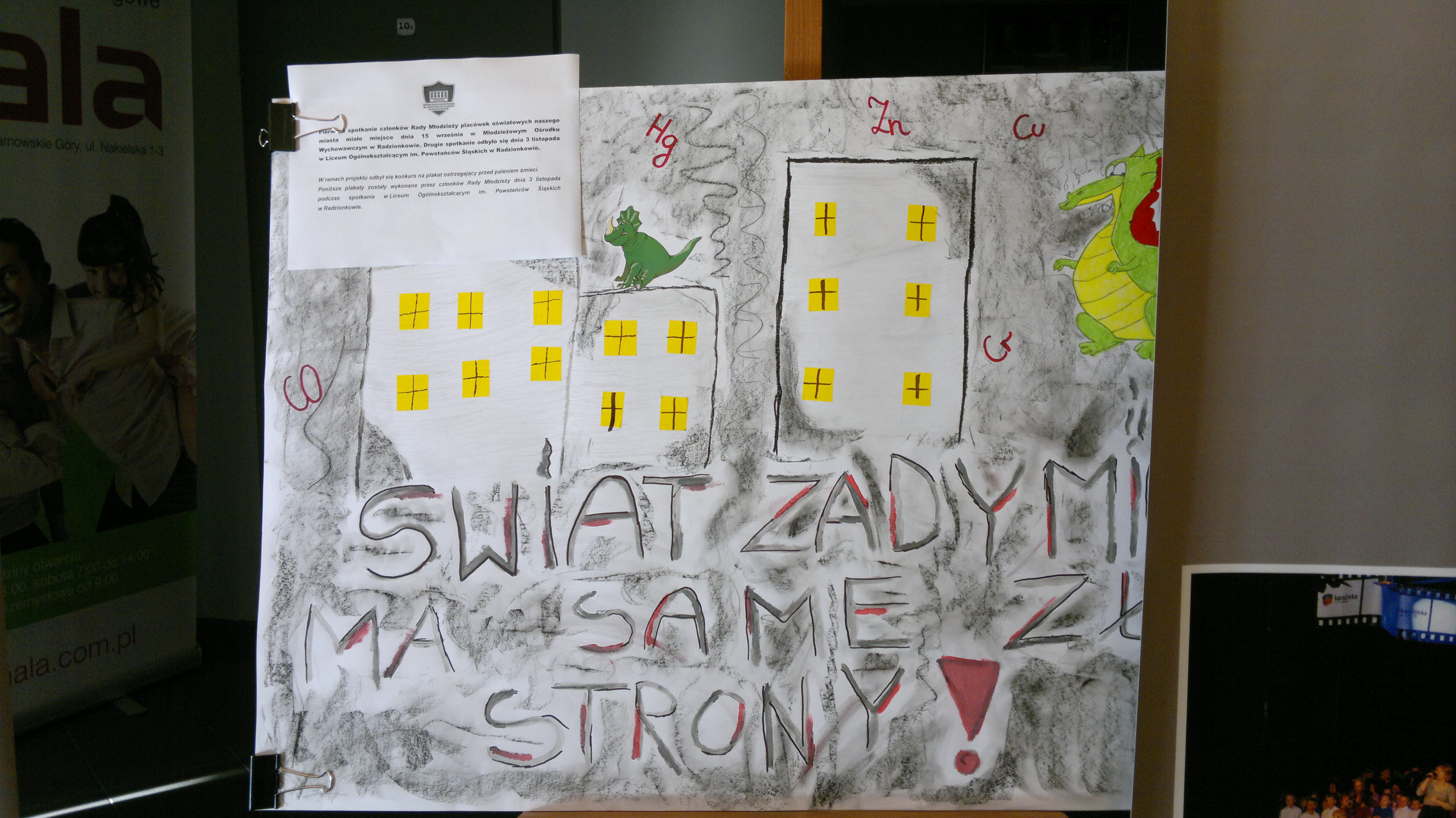 Plakat przedstawiający budynki z napisem świat zadymi ma same złe strony